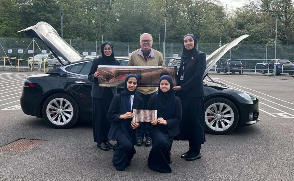 Stuart with students from Tauheedul Islam Girls’ High School and Sixth Form College, Blackburn, displaying solar sheets.